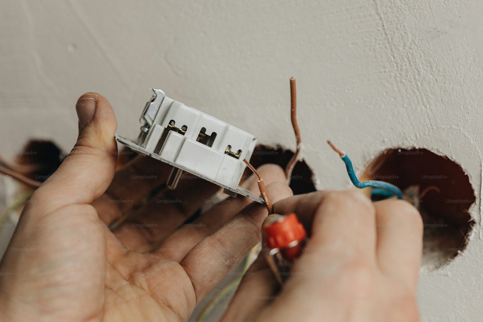 Professional electrician working in a Andover home